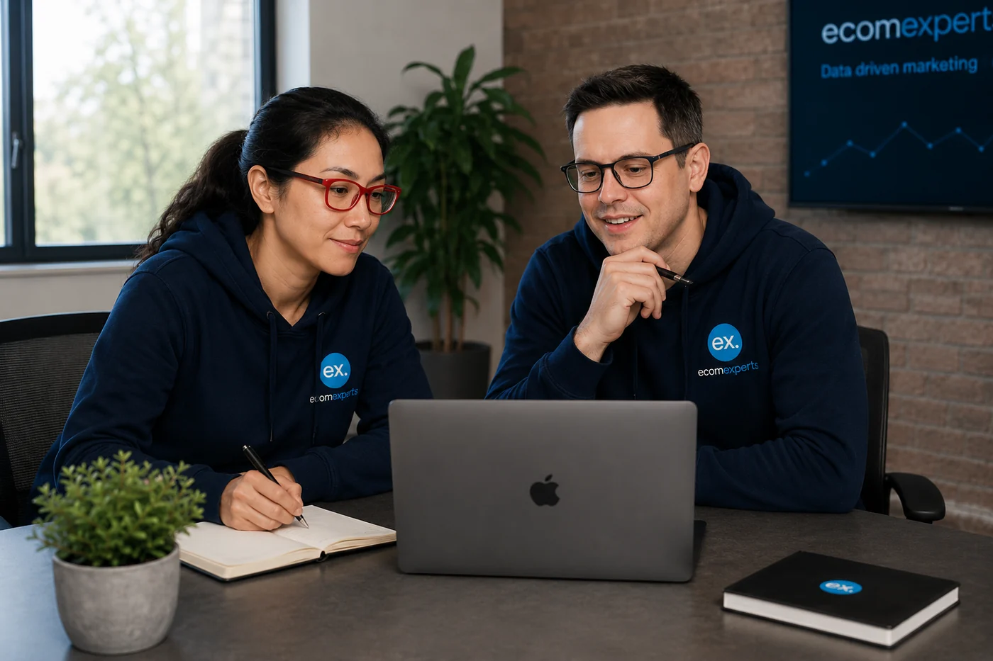 EcomExperts local SEO team collaborating at a laptop